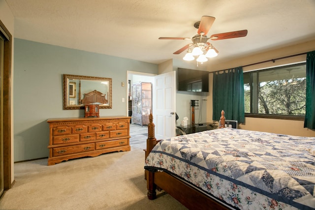 bedroom featuring light carpet and ceiling fan