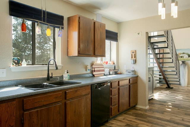 kitchen with dishwasher, sink, hanging light fixtures, dark hardwood / wood-style floors, and a notable chandelier