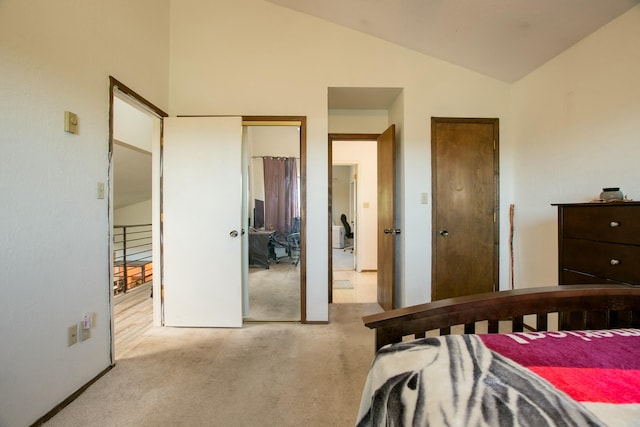 carpeted bedroom with high vaulted ceiling and a closet