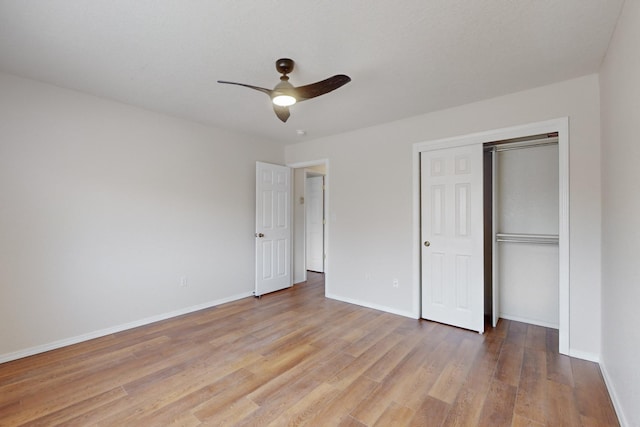 unfurnished bedroom with ceiling fan, light hardwood / wood-style flooring, and a closet