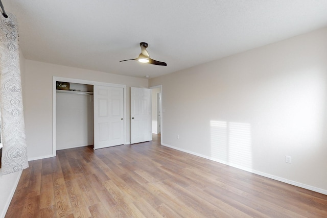 unfurnished bedroom with light wood-type flooring, a closet, and ceiling fan