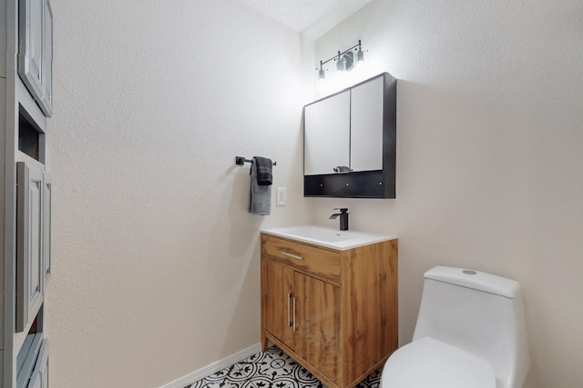 bathroom featuring tile patterned floors, vanity, and toilet