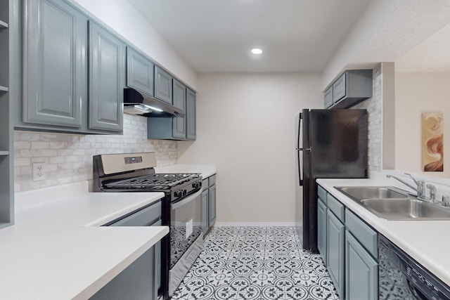 kitchen with refrigerator, tasteful backsplash, gas range, sink, and black dishwasher