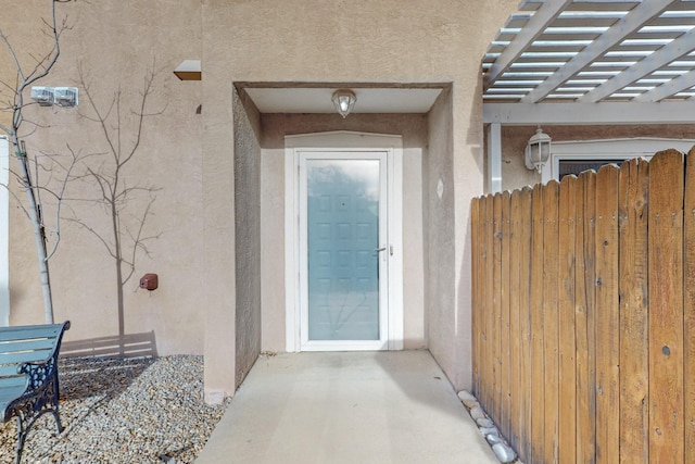 property entrance featuring a pergola