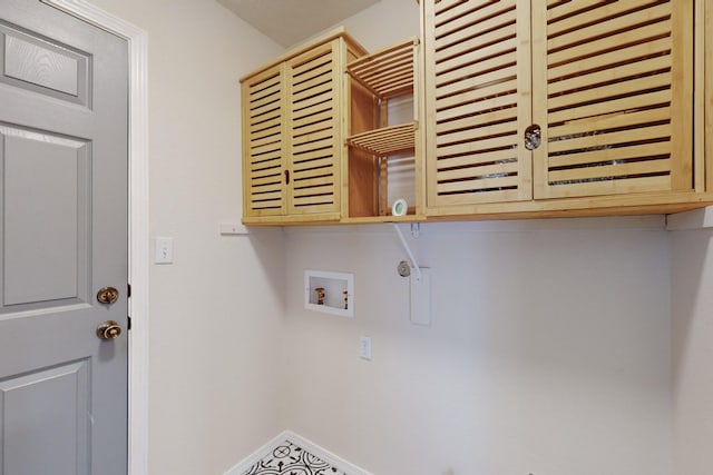 laundry area featuring hookup for a washing machine and cabinets