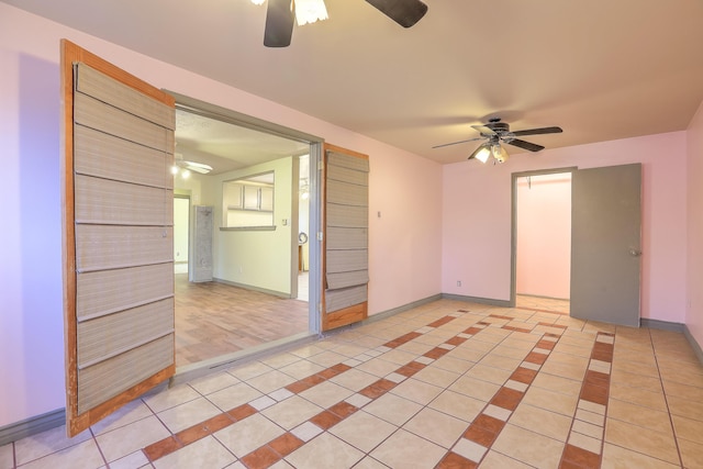 tiled empty room with ceiling fan