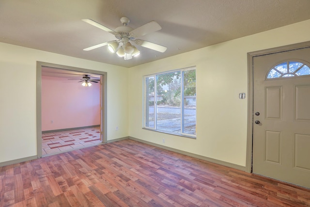 entryway with ceiling fan and light hardwood / wood-style flooring