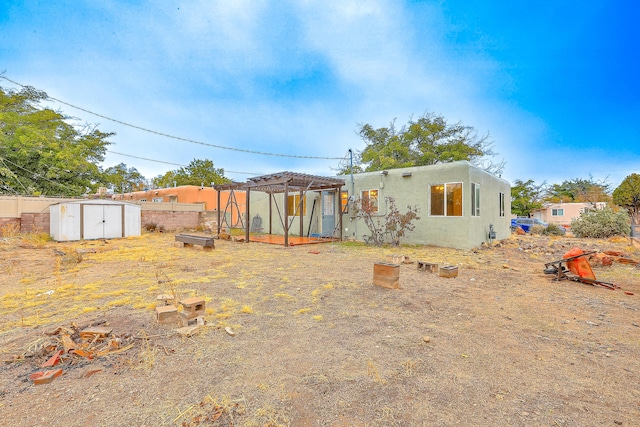 rear view of property with a storage unit and a pergola