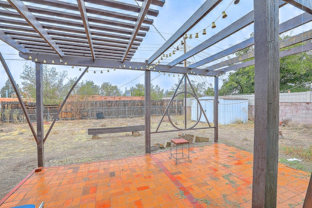 view of patio / terrace featuring a pergola and a storage unit