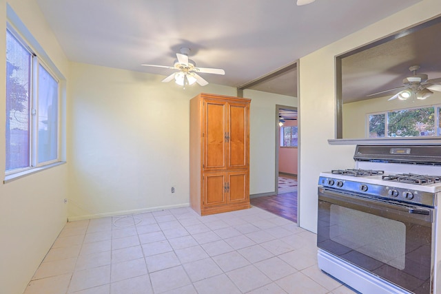 kitchen with white range with gas cooktop and light tile patterned floors