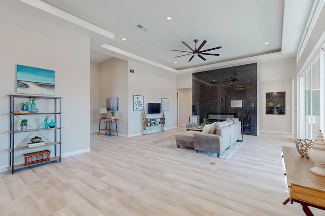 living room featuring ceiling fan and light wood-type flooring