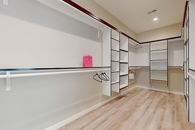 spacious closet with light hardwood / wood-style floors