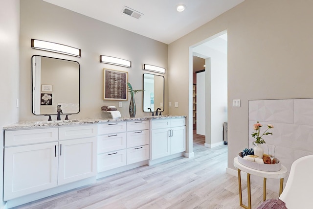 bathroom with wood-type flooring and vanity