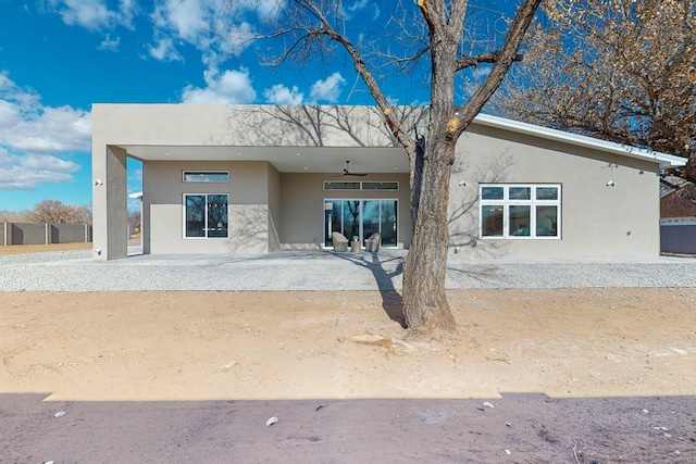 back of property featuring ceiling fan and a patio area