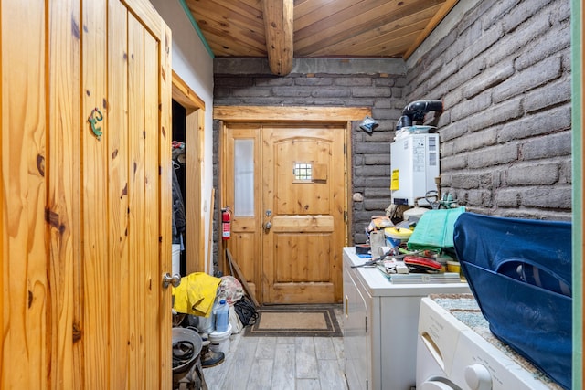 laundry area with washing machine and dryer, wood ceiling, brick wall, and light hardwood / wood-style flooring