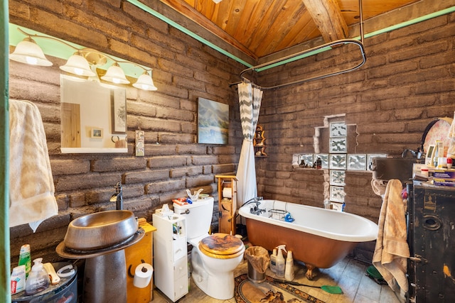 bathroom featuring wood ceiling, a bathing tub, and brick wall