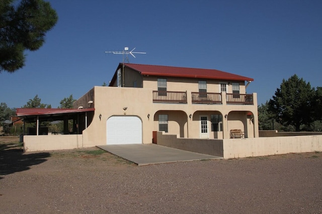 view of front facade featuring a garage and a balcony