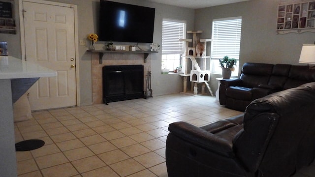 tiled living room with a tiled fireplace and plenty of natural light