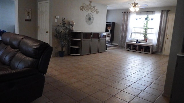 tiled living room featuring ceiling fan