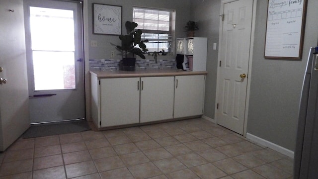 kitchen featuring white cabinetry and light tile patterned floors