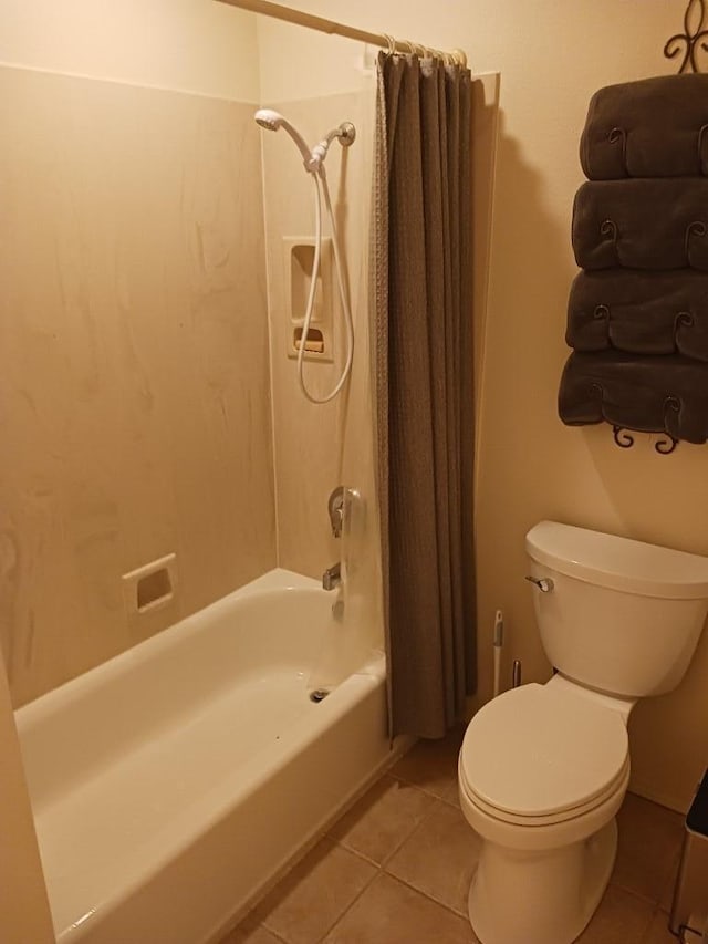 bathroom with tile patterned floors, toilet, and shower / bath combo with shower curtain