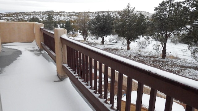 view of snow covered back of property