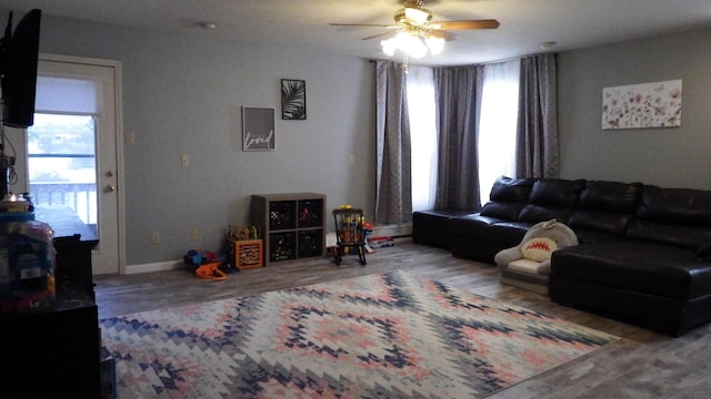 living room with hardwood / wood-style flooring, ceiling fan, and a healthy amount of sunlight