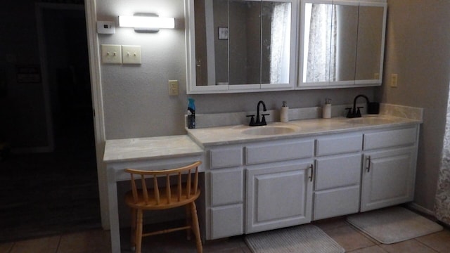 bathroom with tile patterned floors and vanity