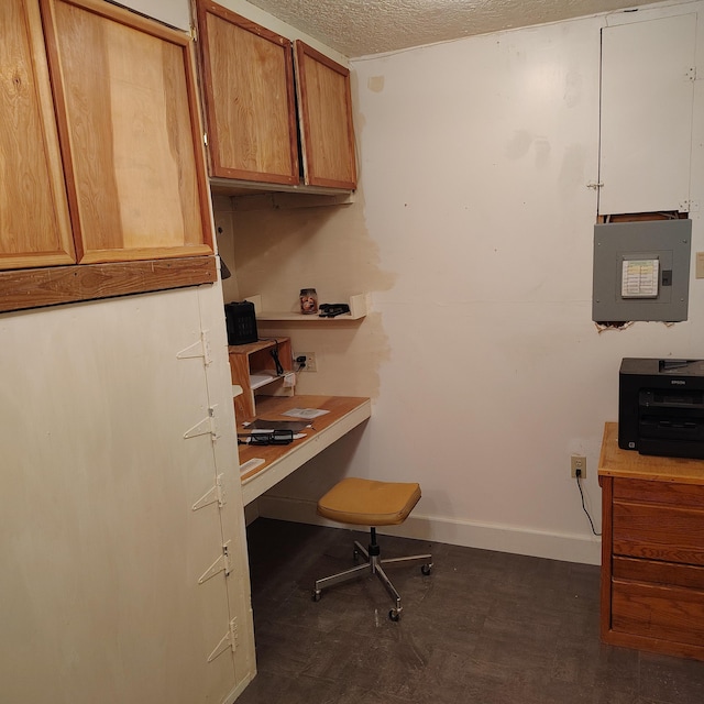 home office with electric panel and a textured ceiling