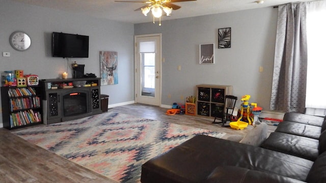 living room featuring ceiling fan and hardwood / wood-style floors