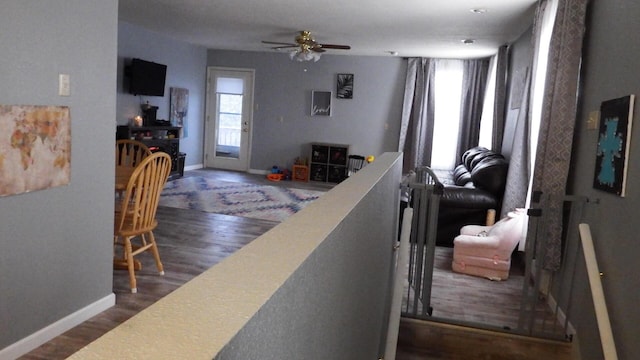 interior space with ceiling fan and wood-type flooring