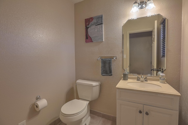 bathroom featuring tile patterned flooring, vanity, and toilet