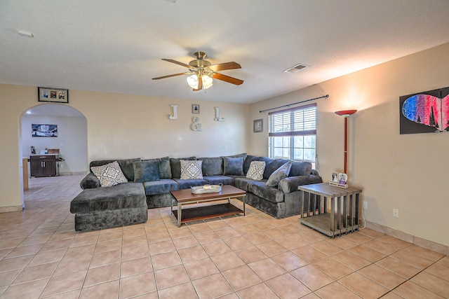 living room featuring ceiling fan and light tile patterned floors