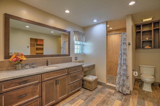 bathroom featuring vanity, toilet, and curtained shower