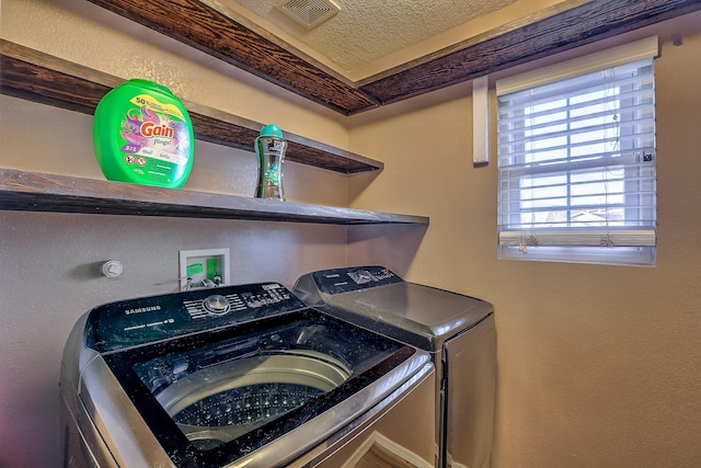 clothes washing area with washer and dryer