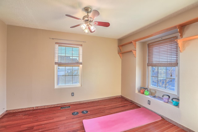 spare room with ceiling fan and wood-type flooring