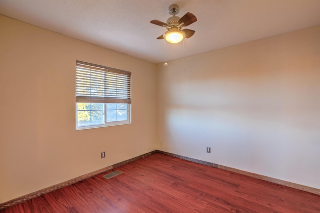 unfurnished room with hardwood / wood-style flooring and ceiling fan