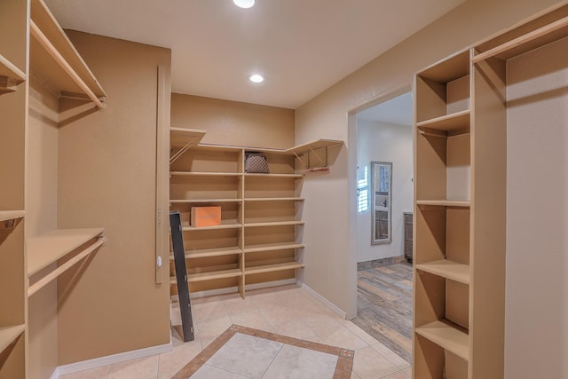 spacious closet with light tile patterned floors