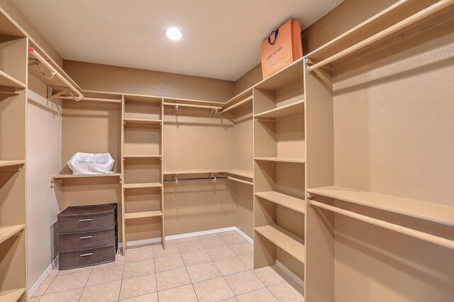 spacious closet featuring light tile patterned floors