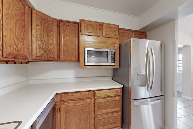 kitchen featuring light tile patterned flooring and appliances with stainless steel finishes