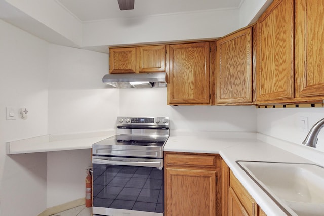 kitchen featuring tile patterned floors, stainless steel electric range, sink, and exhaust hood