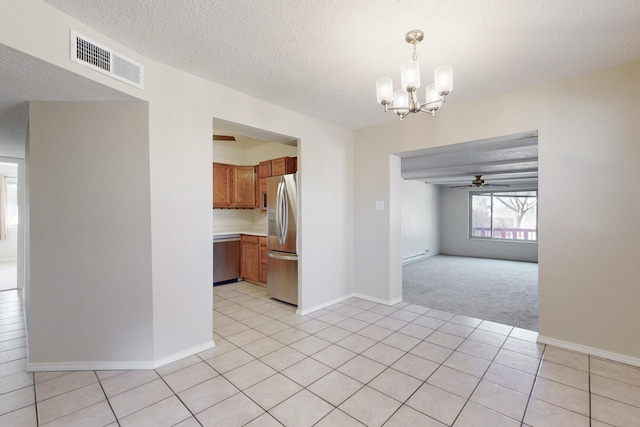 empty room featuring light carpet, a textured ceiling, and ceiling fan with notable chandelier