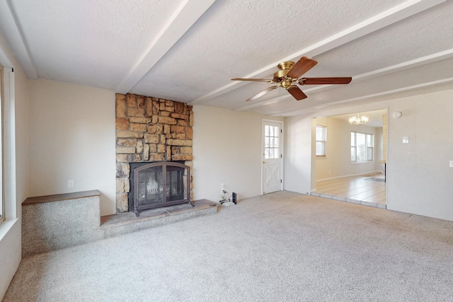 unfurnished living room with light carpet, a textured ceiling, a stone fireplace, and ceiling fan