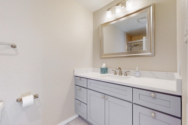 bathroom featuring tile patterned flooring and vanity