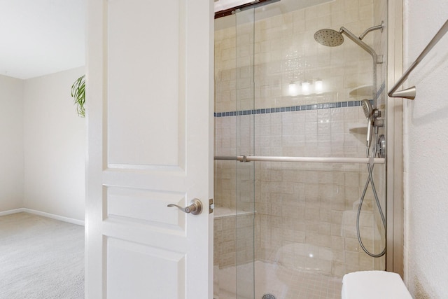 bathroom with an enclosed shower and toilet