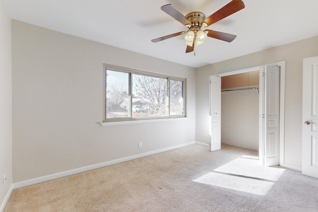 unfurnished bedroom with ceiling fan, light colored carpet, and a closet