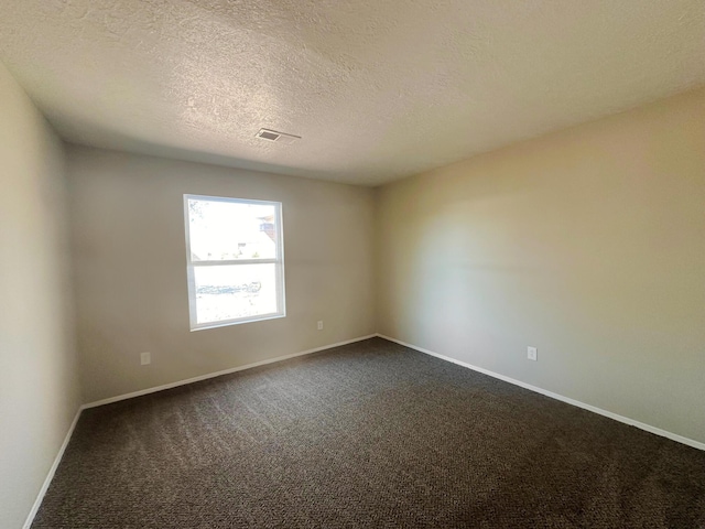 carpeted spare room with a textured ceiling