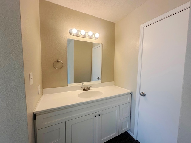 bathroom featuring vanity and a textured ceiling