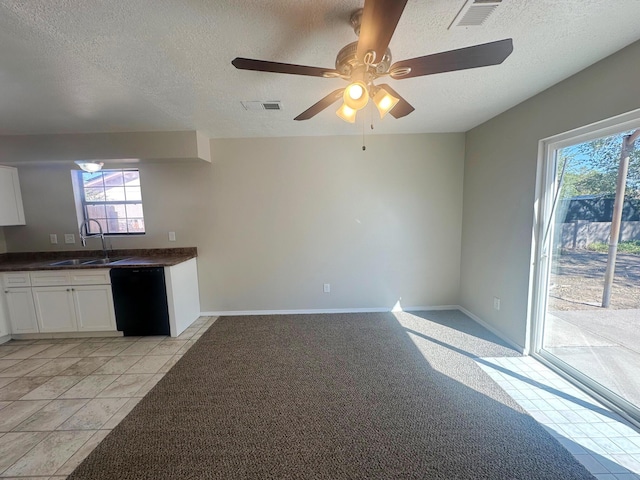 kitchen with white cabinetry, dishwasher, ceiling fan, sink, and light colored carpet