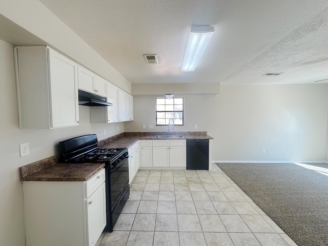 kitchen featuring a textured ceiling, light colored carpet, sink, black appliances, and white cabinetry